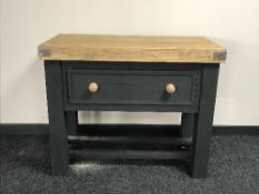 A reclaimed pine butchers block fitted a drawer on a painted base