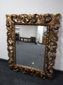 A contemporary gilt framed Rococo style mirror