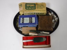 A papier mache tray containing a vintage boxed Spong mincer,