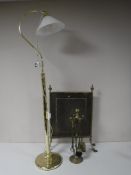 A brass floor lamp with shade,