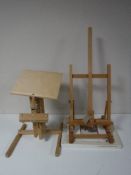 Two folding easels, together with a boxed tapestry frame,