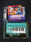 Four boxes of assorted board games, electricals, turn table,