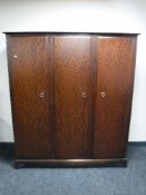 A Stag Minstrel triple door wardrobe in a mahogany finish