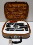 A cased five piece Corton clarinet,