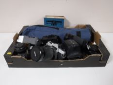 A box containing Chinon, Minolta, Practika cameras, camera lenses, Cine camera