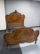 A 4' Louis XV style French walnut bed frame with carved Rococo detail