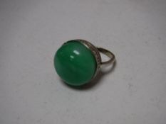 A jade ring set in white metal