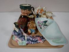 A tray containing a Royal Doulton 'Mr Pickwick' character jug, art deco figurine, Carlton ware dish,