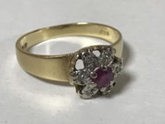 An 18ct gold ruby and diamond cluster ring, size K/L, 2.6g.