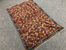 An Eastern carpet with multi colour design 195cm x 127cm