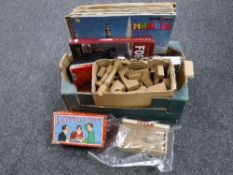 Three boxes containing assorted china records, wooden games, kitchen ware,