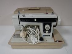 A cased Newholm Deluxe Zig Zag sewing machine