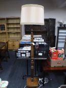 An early 20th century carved oak standard lamp