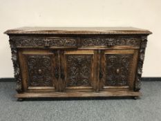 A Victorian carved oak sideboard,