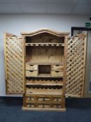 A Mexican pine cocktail cabinet with lattice doors