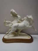 A Royal Worcester figure - galloping horses,