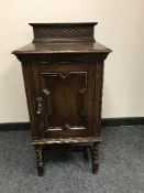 An Edwardian oak bedside cabinet,