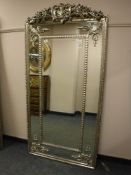 An ornate silvered mirror,