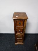 A narrow mango wood four drawer chest
