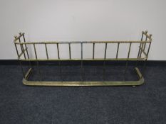 An antique brass fire guard