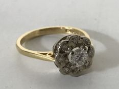 An 18ct gold diamond cluster ring, the central stone estimated at 0.