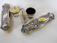 A pair of Art Nouveau silver backed hand brushes and a three piece silver cruet set