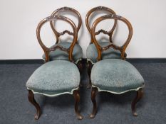 A set of four Victorian mahogany balloon back chairs on cabriole legs