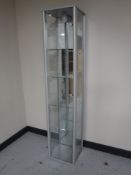 A contemporary narrow glass display cabinet