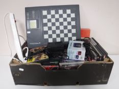 A box containing assorted DVD's, board games, portable radio,
