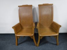 A pair of pitch pine throne armchairs