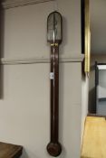 An antique mahogany stick barometer