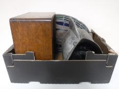 A box containing an oval stained glass religious panel (a/f) a curling stone,