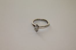 An 18ct white gold solitaire diamond ring, a marquise cut stone within a claw setting,