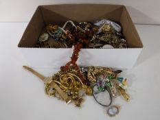 A box of costume jewellery - brooches, necklaces etc.