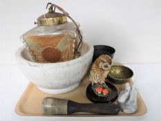 A tray containing a large pestle and mortar, a cast iron mortar, brass embossed bowl,