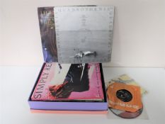 A box of LP records, 45's and 12 inch singles including KLF, The Cure,