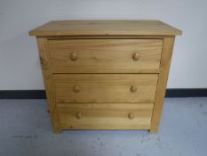A pine three drawer chest