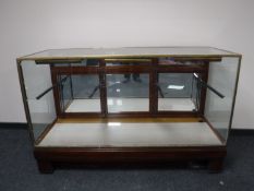 An early twentieth century brass framed shop display cabinet