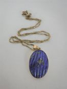 A gold mounted lapis lazuli pendant on chain