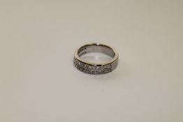 An 18ct white gold diamond half eternity ring,