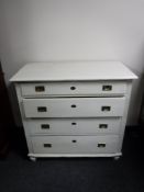 An early twentieth century painted pine four drawer chest with brass drop handles