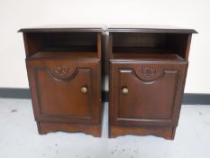 A pair of bedside cabinets in a mahogany finish