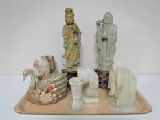 A tray containing a pair of soapstone figures, Eastern Deities, marble goblets, bookends,