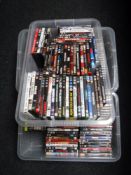 Three plastic storage crates of assorted DVDs