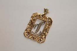 A 14ct gold pendant set 'L' in diamonds, 10.6g.
