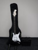 An electric guitar and carry strap, together with a B.B.