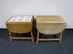 A blond oak drop leaf tile topped coffee table,