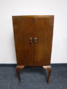 A twentieth century oak music cabinet