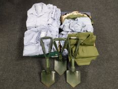 Two boxes containing army surplus shirts, three military shovels,