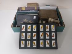 A box containing a quantity of cigarette card albums and assorted cigarette cards (many sets)